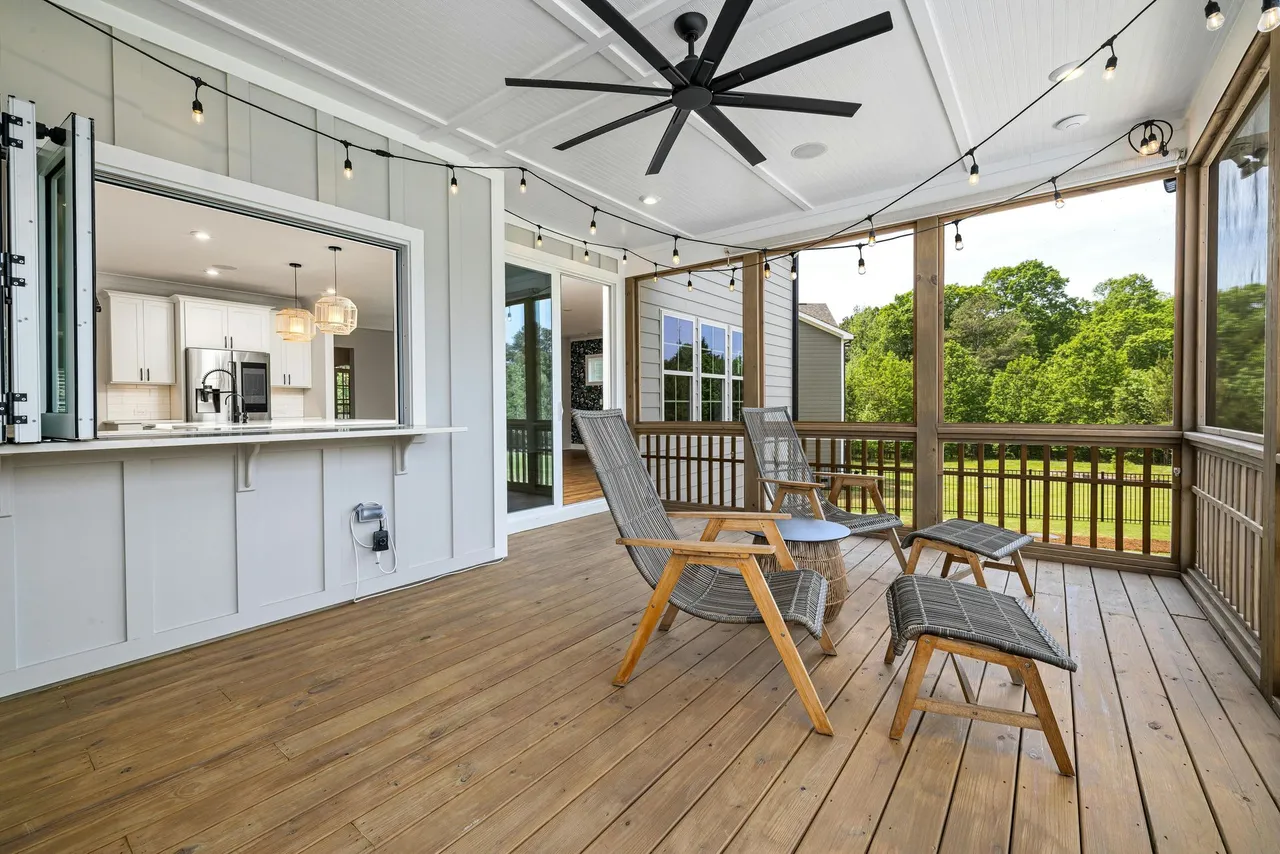 A man is sitting in a rocking chair on a porch.